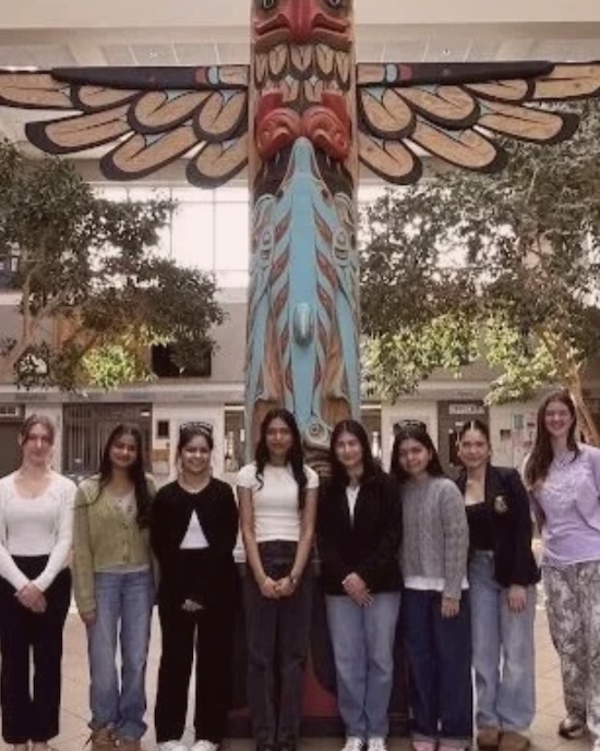 Nanaimo Highschool students in front of a large Totem