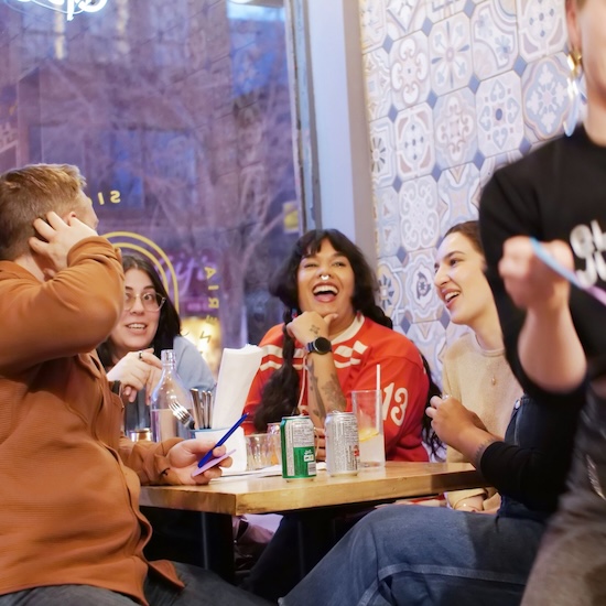 People laughing around a table