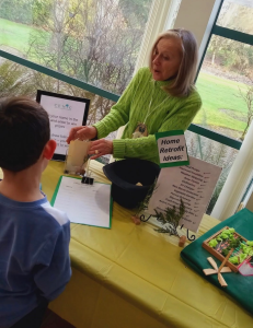 A woman talking to a child at an event
