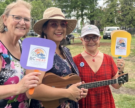 Three ladies holding signs that say "BC Heat Collaborative"